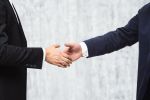 Insider Trading Concept - Businessmen shaking hands