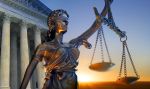 A statue of the blindfolded lady justice in front of the United States Supreme Court building - federal investigative agencies concept