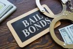 Plate Bail bonds and handcuffs on it - bail in federal court concept
