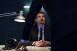Arrested businessman and detective in interrogation room. FBI Interrogation Concept.